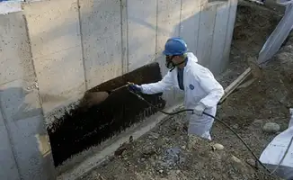 Professional waterproofing the exterior walls of the basement in Fort Collins, CO