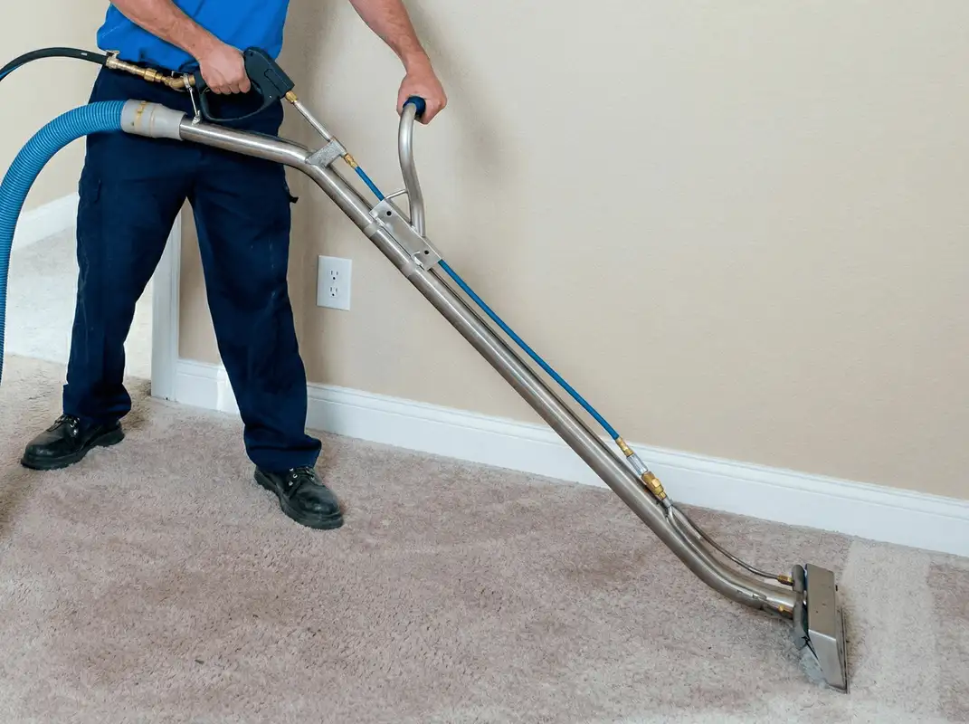 Professional operating a liquid removal machine on a carpeted floor in Fort Collins, CO
