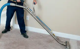 Professional operating a liquid removal machine on a carpeted floor in Fort Collins, CO